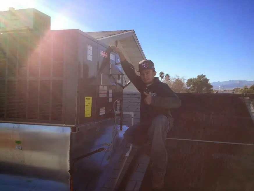 HVAC technician performing Boiler Repair on a rooftop unit in Chevy Chase